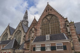 Gothic church with impressive windows and towers under a cloudy sky, Amsterdam, Netherlands