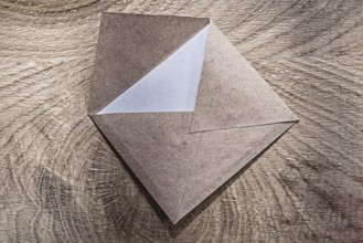 Vintage envelope on wooden board top view