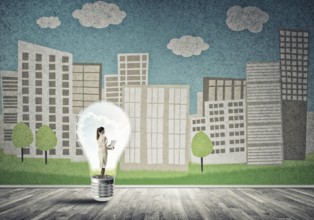 Businesswoman inside light bulb against city drawn concept