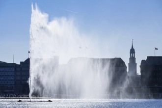 Alster fountain on the Inner Alster Lake, Jungfernstieg and Michel in Hamburg, Germany, Europe