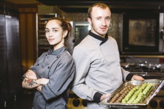 Profession preparation confectionery products. Caucasian man and woman two employees colleague