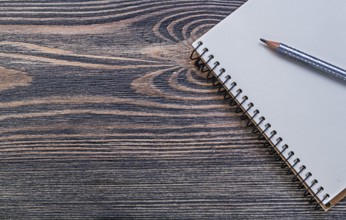 Open notepad pencil on vintage wooden board education concept