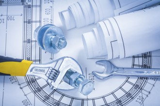Adjustable key spanner bolts nuts and blueprints construction concept