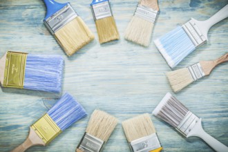 Paintbrushes on wooden board construction concept