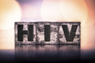 The word HIV written in vintage ink stained letterpress type