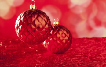 Christmas card of red capiton bauble on blurred background