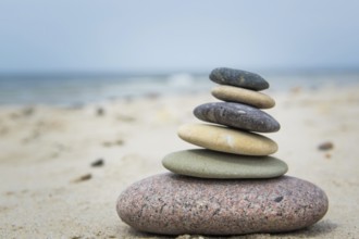 Round pebbles on the beach in Denmark is a symbol for harmony. Stones on the beach in Denmark is a