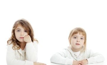 Blond and brunette kid girls portrait on white desk table