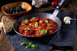 Baked mini balls in tomato sauce with basil