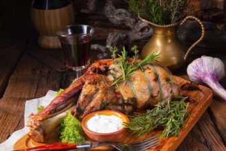 Grilled shoulder of lamb braised in the oven with rosemary
