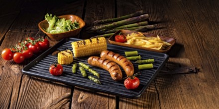 Grilled krakauer with french fries and green salad