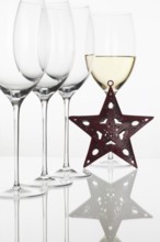 Four glasses of wine and Christmas decoration on the white background