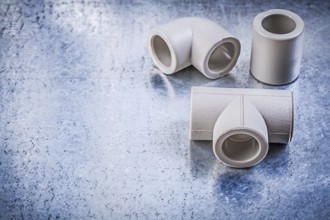 Plastic pipe connectors on metallic surface construction concept