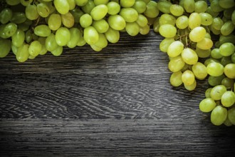 Branch of grapes on wooden board food concept