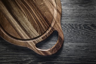Round chopping board on wood background