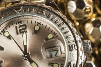 Shiny gold color watch. Studio macro shot