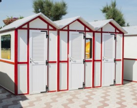 Red wooden cabins on the beach