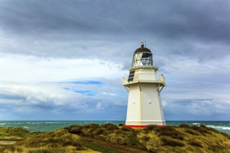 Independent trip to New Zealand. The snow-white lighthouse of Waipapa is visible on the horizon.