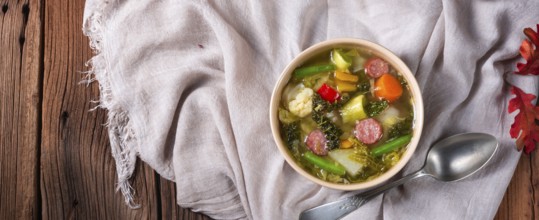 Delicious autumn vegetable soup with sausage and bacon