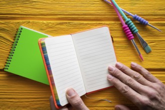 Back to school supplies notebook an brushes vivid colorful neon teachers hand