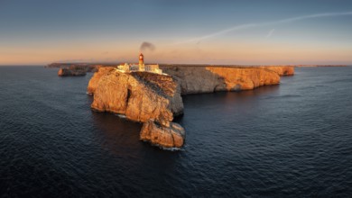 Portuguese coast with a lighthouse in the rays of the setting sun, Cabo De Sao Vincente on sunset