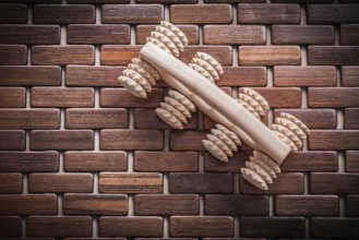 Wood massager with handle on textured wooden mat healthcare concept