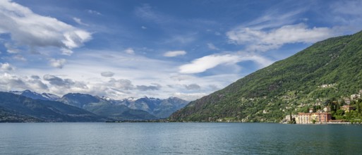 A view of the Bay of Bellano on Lake Como in summer under a blue sky