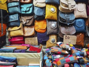 Handmade colourful leather bags and purses on display at traditional souk - street market in