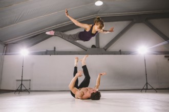 Young couple Couple practicing acro yoga in gym. Healthy lifestyle. Acroyoga. Couple yoga. Partner