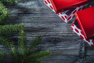 Wrapped present box pine branches on vintage wooden board