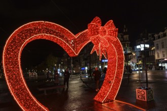 Large red heart of lights illuminates street scene at night, Amsterdam, Netherlands