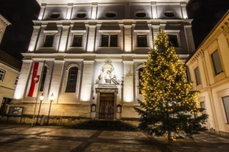 Illuminated Christmas tree in front of church, St. Xaver parish church, night shot, Leoben, Styria,