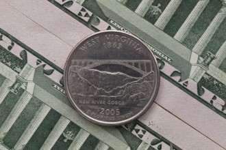 A quarter of West Virginia on US dollar bills. Symmetric composition of US dollar bills and a