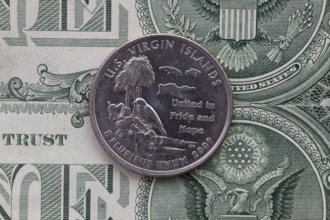 A quarter of U.S. Virgin Islands on US dollar bills. Symmetric composition of US dollar bills and a