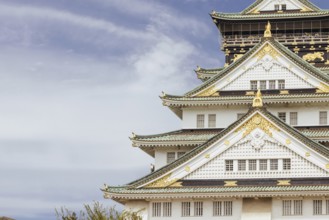 OSAKA, JAPAN - SEPTEMBER 25 2024: The iconic Osaka Castle and lush surrounds on a warm clear autumn