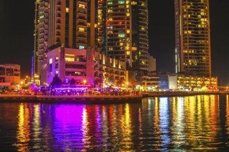 Dubai Marina Walk illuminated at night. Dubai Marina is a newly futuristic district, famous for