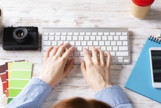 Freelancer sitting at desk and typing on keyboard. Business occupation and innovation. Office