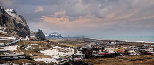 An aerial view of a chapel on top of a hill over Vik, Iceland in the middle of a field. Photo of a