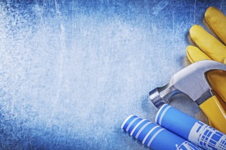 Protective working gloves blue rolled construction drawings claw hammer