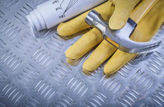 Claw hammer leather protective gloves construction drawings on corrugated metal sheet