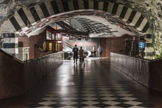 Stockholm, Sweden, 07 24 2019- Decorated interior of the underground metro with a young couple