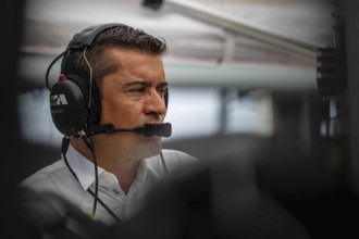 INDYCAR team owner, RICARDO JUNCOS, watches his team work on their Juncos Hollinger Racing car