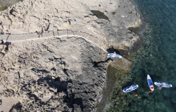 Done view of unrecognized people kayaking in the sea. People active, healthy lifestyle. Cape Grego