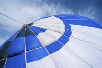 Blue Balloon in the blue cloudy sky