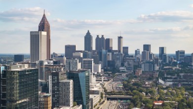 Aerial views of Atlanta showcase a vibrant cityscape with sleek skyscrapers, lush green spaces, and