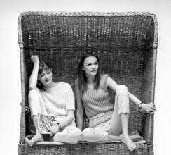 In the 1960s. Two fashion models, in typical 1960s summer outfits photographed in a studio wearing