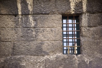 The nostalgic window of an old building with escape-proof iron bars as window grilles