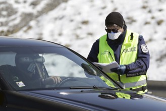 Sofia, Bulgaria - 3 April, 2020: A police officer checks a car drriver at one of the exits of