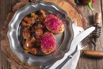 Ratatouille with baked potato and beetroot sprouts