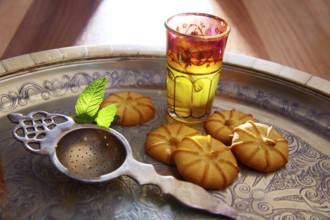 Green tea with mint Moroccan style on silver tray and biscuits
